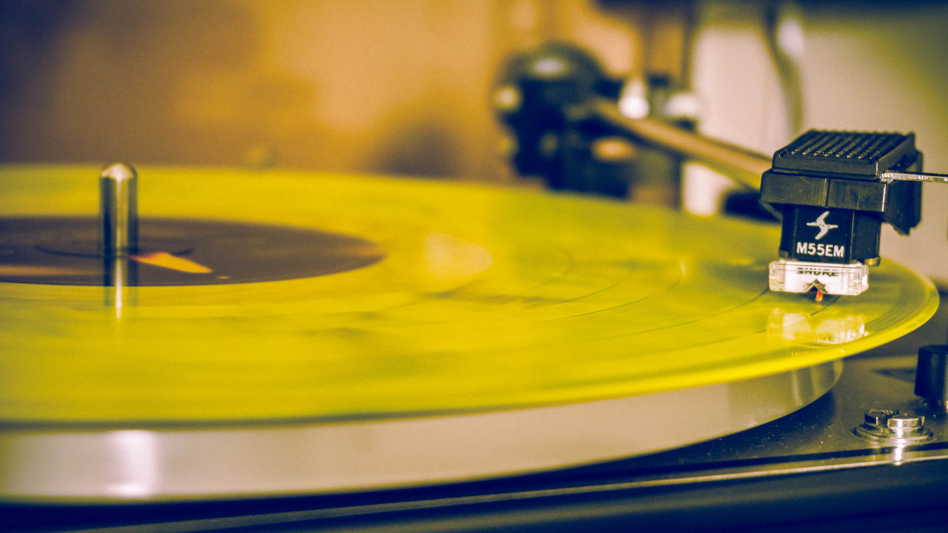 Yellow record spinning on the turntable
