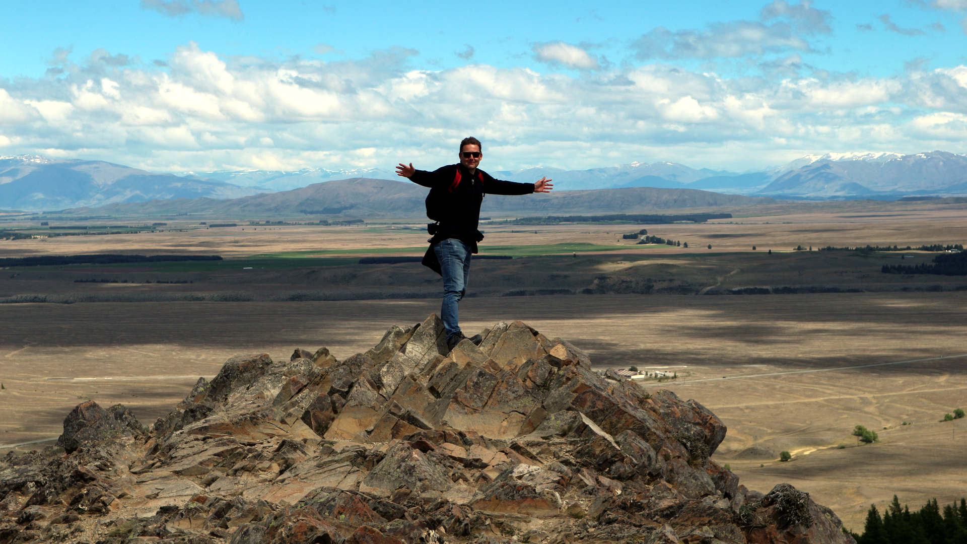 Martijn standing on rocks after a hike to the top
